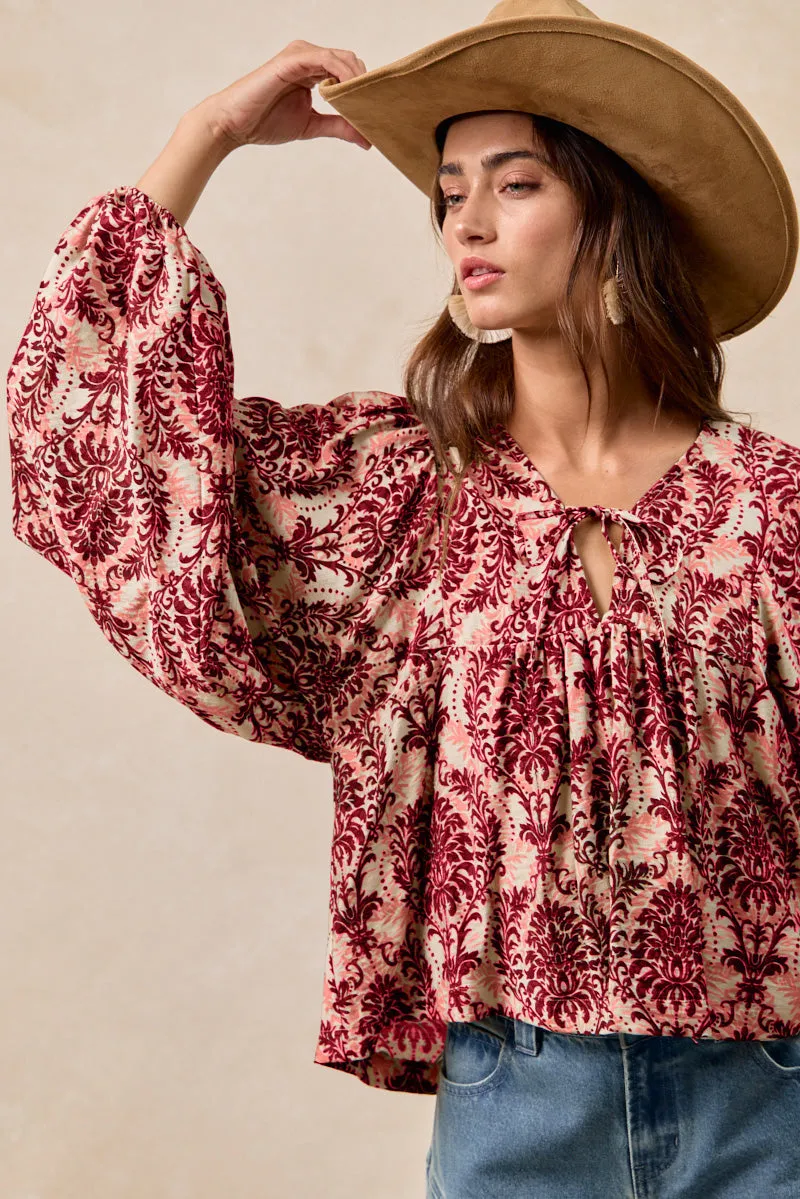 IT4534S-04 | PRINTED WOVEN FRONT TIED TOP WITH BALOON SLEEVE Metallic accents smooth zipper